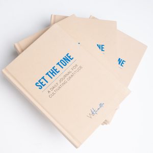 Set the Tone gratitude journals stacked, cream linen cover with blue title