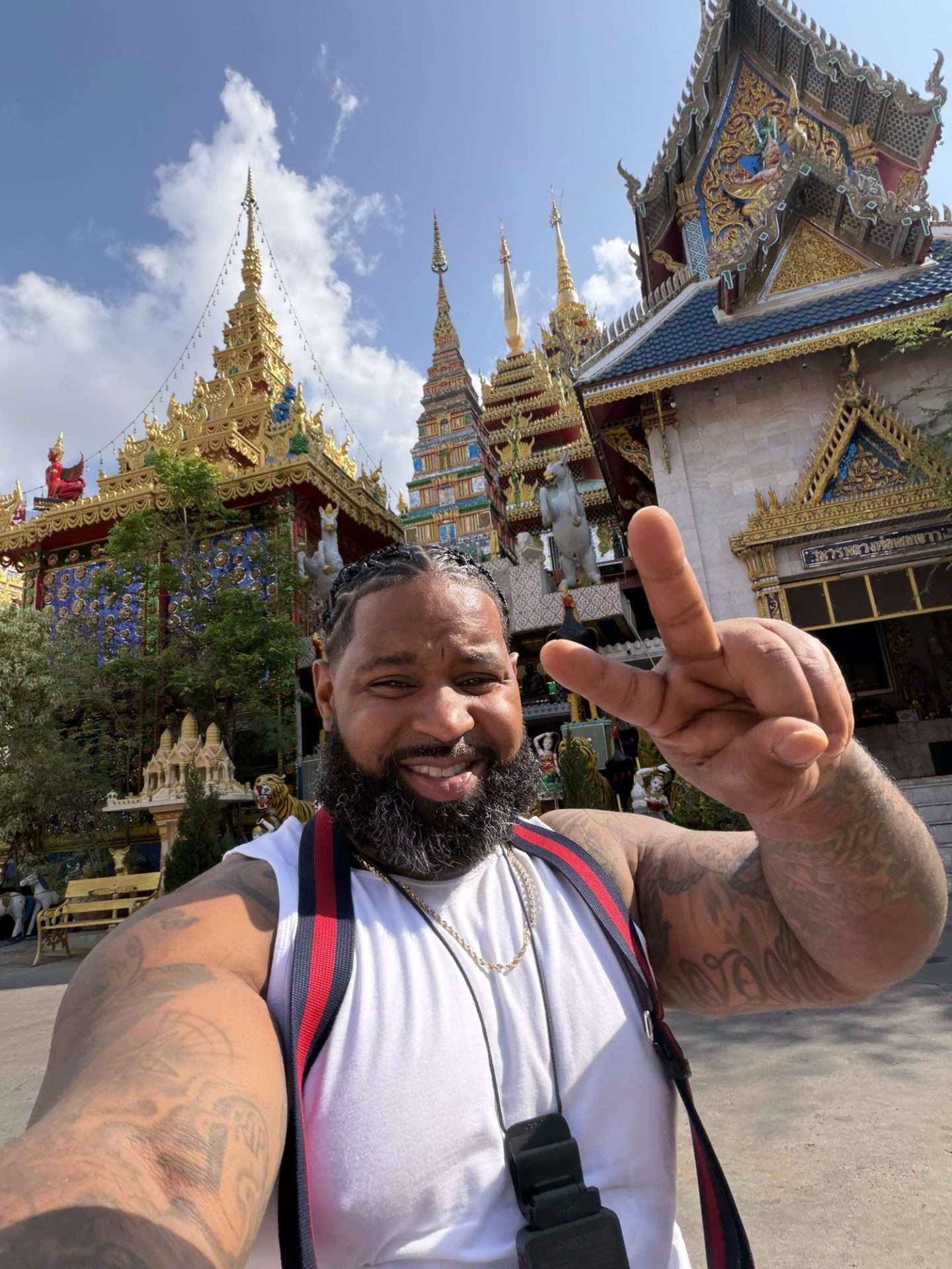 Wesley Hamilton smiling in front of a temple in Bangkok