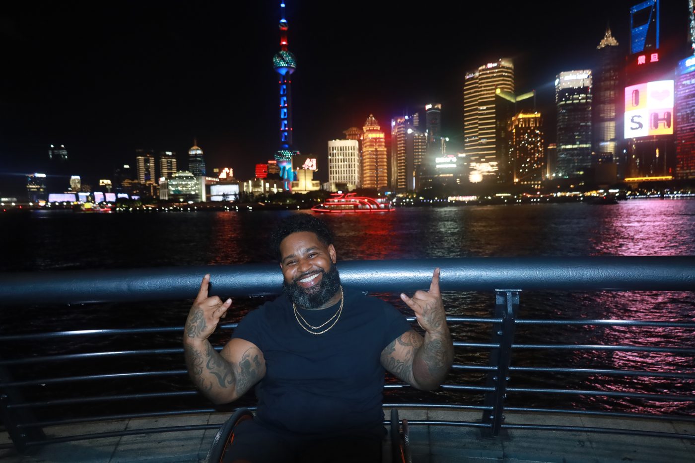 Wesley Hamilton at night in front of The Bund skyline in Shanghai