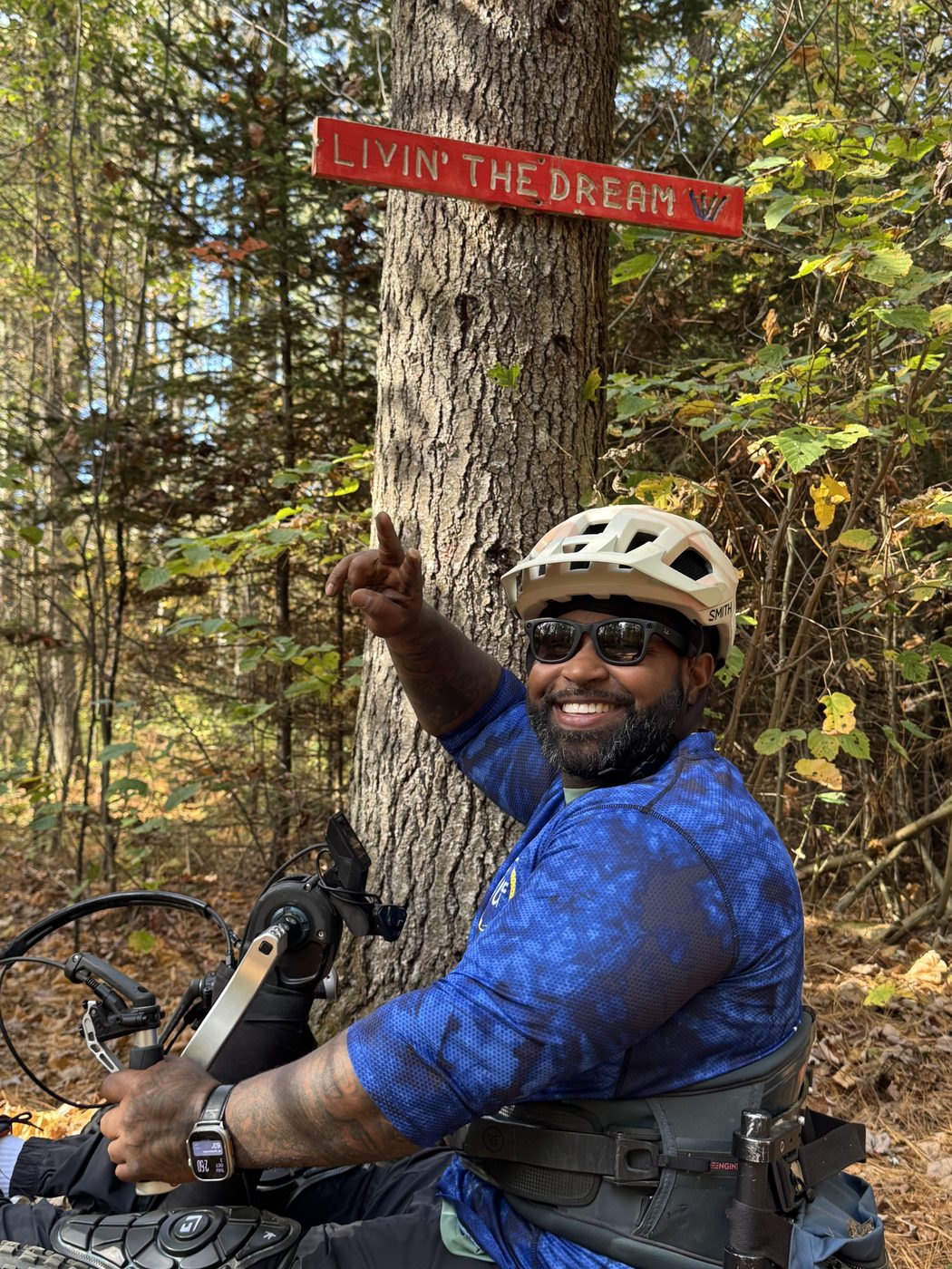 Wesley Hamilton on an adaptive mountain bike in the Vermont woods in fall